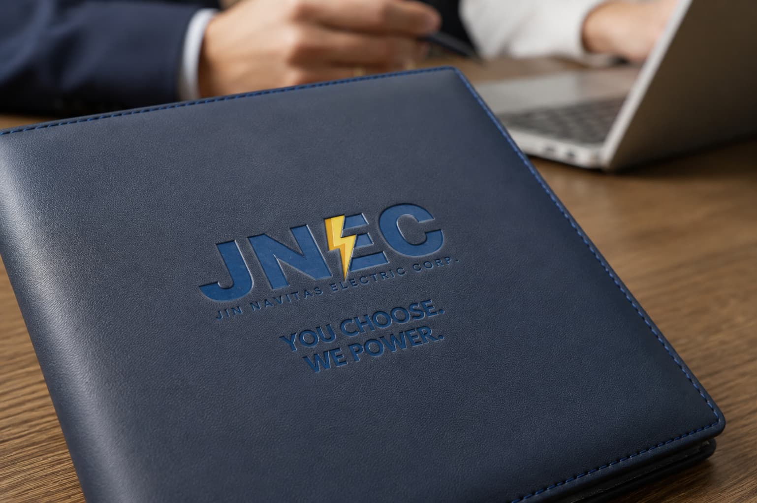 Business representatives reviewing switching documents with JNEC